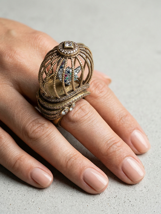 Birdcage songbird statement ring worn on hand